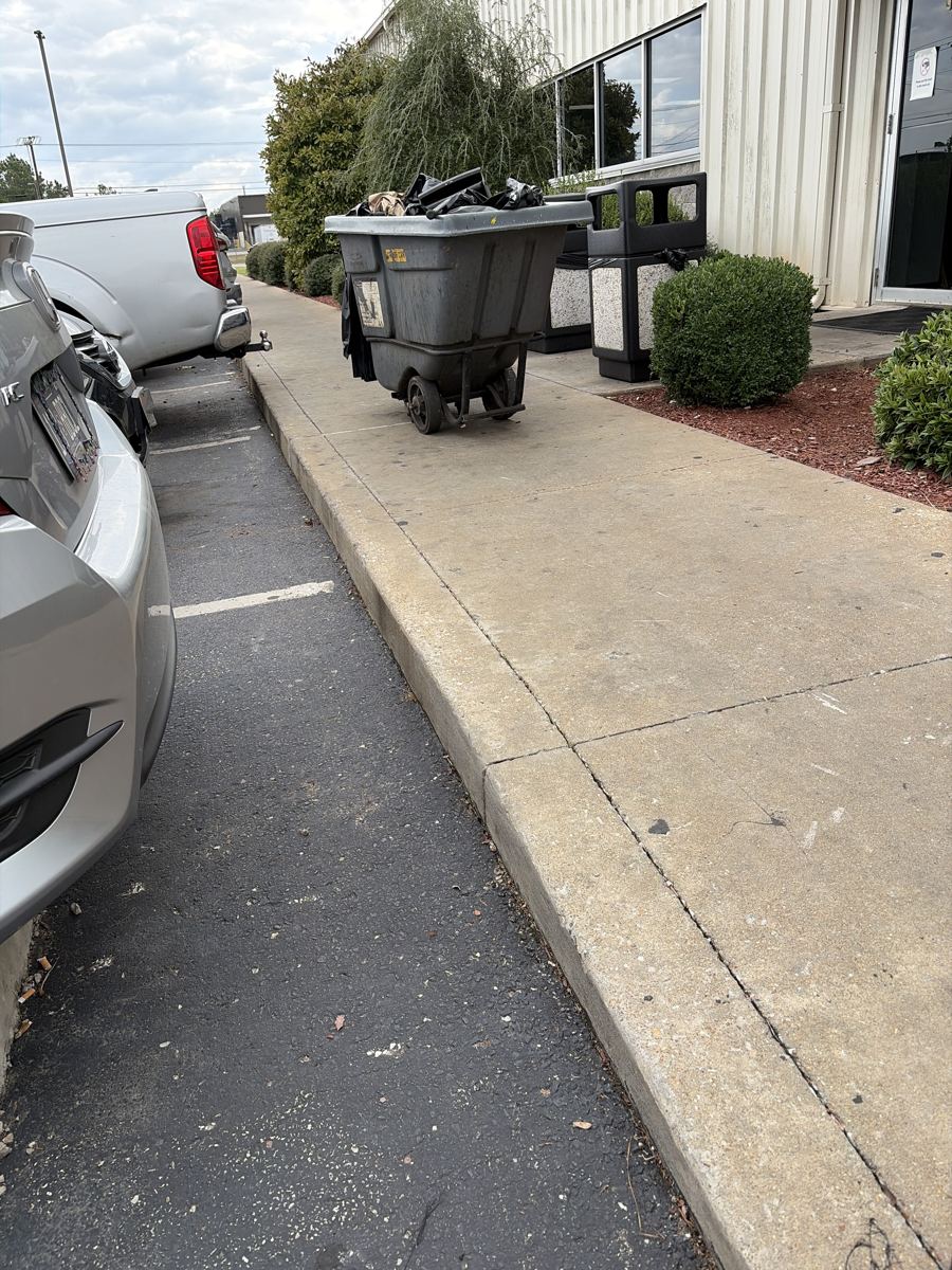 Clean front walkway and landscaped entrance at an industrial plant after OneFive Solutions service
